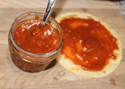 enchilada sauce in a small jar and spread on a corn tortilla