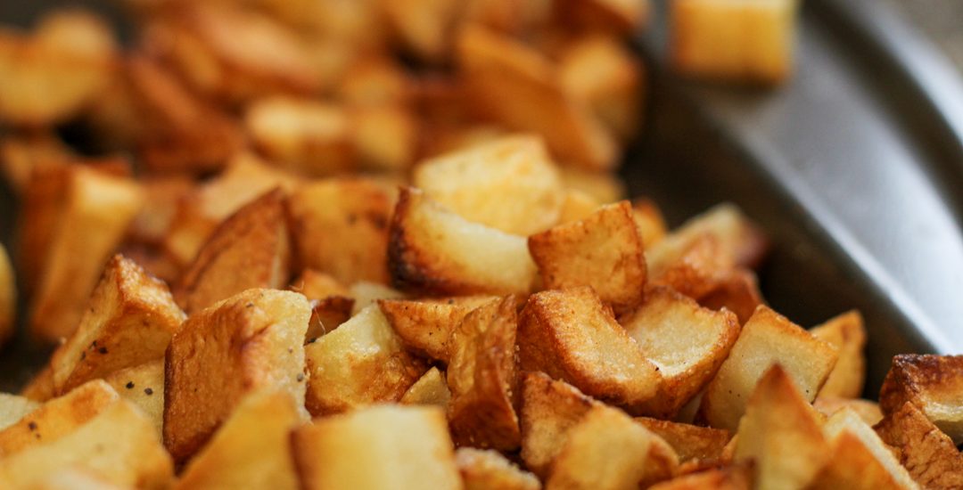 crispy breakfast potatoes on a baking sheet