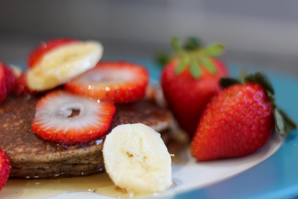 gluten free pancakes topped with strawberries and bananas