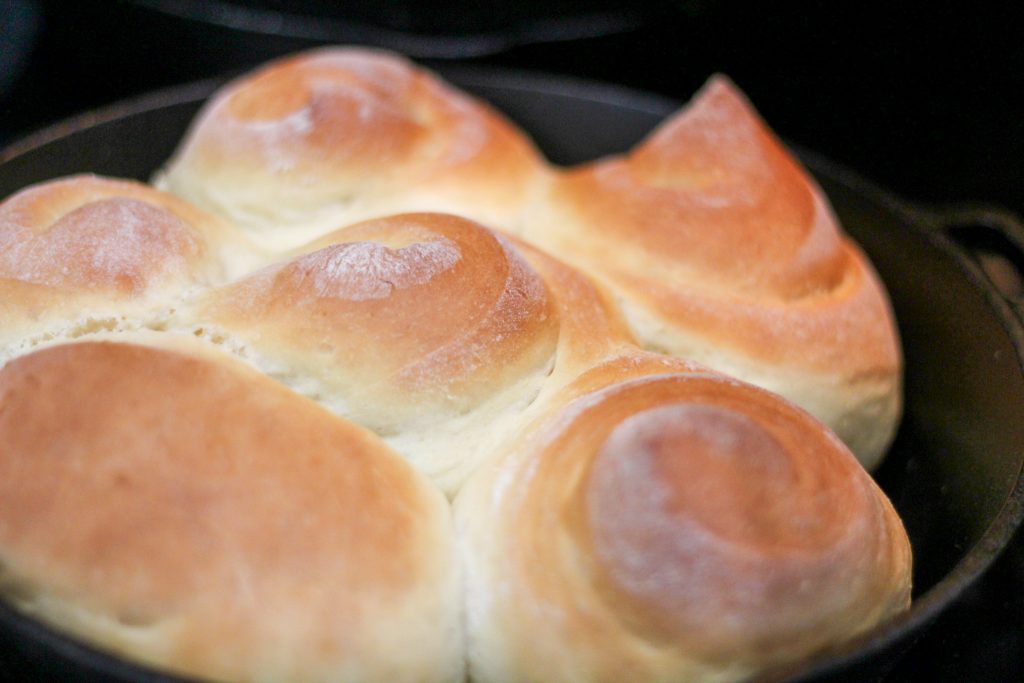 butter rolls in a cast iron skillet